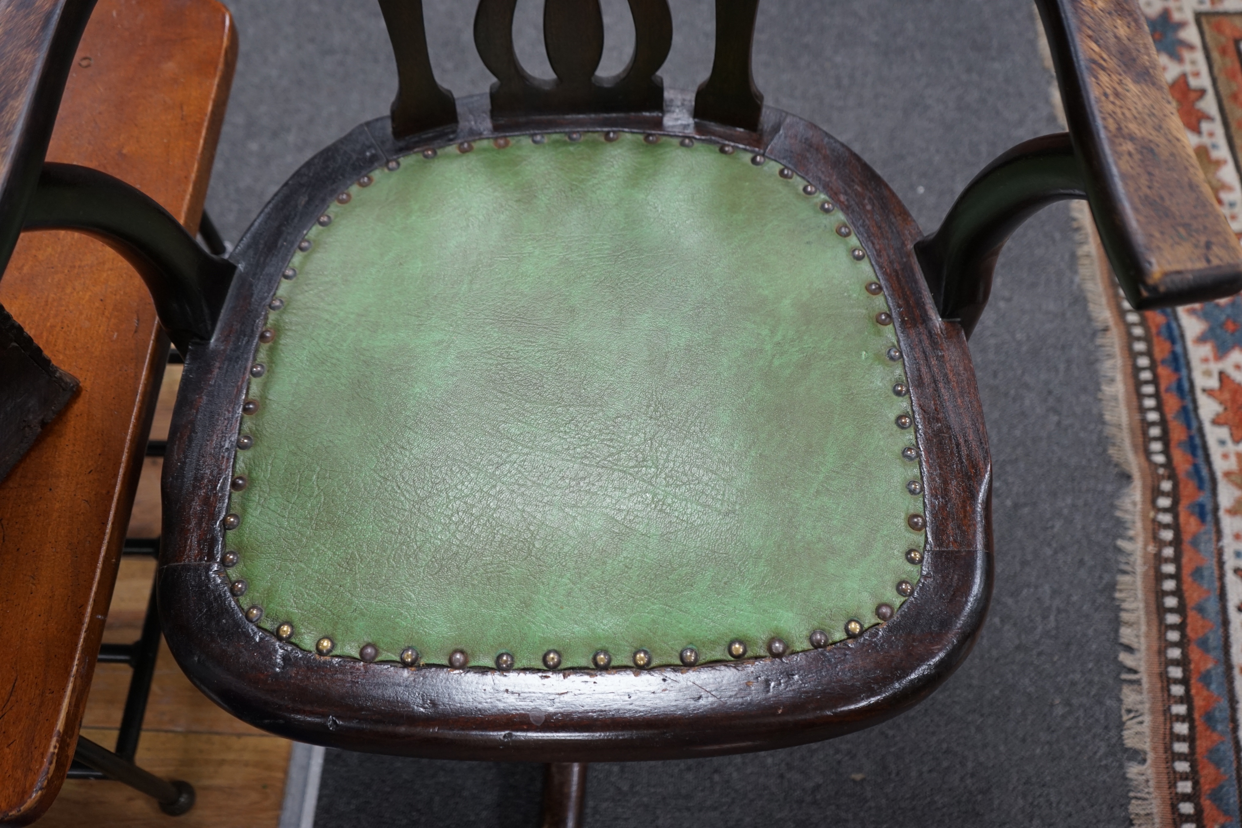 An Edwardian beech revolving office elbow chair